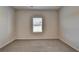 Bedroom featuring neutral-toned carpet and a window at 58 Longhorn Way, Auburn, GA 30011