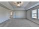 Vast bedroom with tray ceiling, soft carpet, and ample natural light from the window at 58 Longhorn Way, Auburn, GA 30011