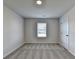 Neutral bedroom with light colored carpet, walls, and single window at 58 Longhorn Way, Auburn, GA 30011