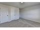 Carpeted bedroom showcases two doors and an access panel at 58 Longhorn Way, Auburn, GA 30011