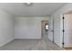 Carpeted bedroom with neutral walls and an open doorway to another room at 58 Longhorn Way, Auburn, GA 30011