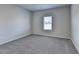 Cozy bedroom with a window and neutral-toned carpet at 58 Longhorn Way, Auburn, GA 30011