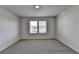 Bright bedroom featuring plush carpeting and a window offering natural light at 58 Longhorn Way, Auburn, GA 30011