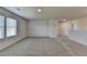 Spacious carpeted bonus room featuring neutral walls and natural light from a large window at 58 Longhorn Way, Auburn, GA 30011