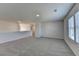 Bright and airy bonus room with carpet flooring and ample natural light from the window at 58 Longhorn Way, Auburn, GA 30011