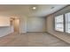 Carpeted bonus room with window offering natural light, ideal for versatile living space at 58 Longhorn Way, Auburn, GA 30011