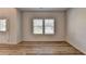 Bright dining area features wood-look floors and plenty of natural light from large windows at 58 Longhorn Way, Auburn, GA 30011