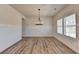 Bright dining room with luxury vinyl plank floors, modern chandelier, and large windows at 58 Longhorn Way, Auburn, GA 30011