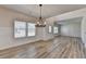 Open-concept dining area features wood-look floors, bright natural light, and modern trim at 58 Longhorn Way, Auburn, GA 30011