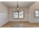Bright dining area features elegant chandelier, wood-look floors, and crisp white trim at 58 Longhorn Way, Auburn, GA 30011