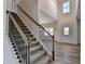 Entryway features carpeted stairs with iron railing and hardwood floors at 58 Longhorn Way, Auburn, GA 30011