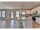 Modern kitchen boasts an island, stainless appliances, and an open floor plan at 58 Longhorn Way, Auburn, GA 30011