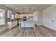 Modern kitchen featuring white cabinets, granite countertops, and a spacious island at 58 Longhorn Way, Auburn, GA 30011
