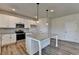 Modern kitchen with granite island, stainless steel appliances, and modern lighting at 58 Longhorn Way, Auburn, GA 30011