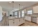 Open kitchen with an island, stainless steel dishwasher, and hardwood floors at 58 Longhorn Way, Auburn, GA 30011