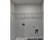 Laundry room with tile flooring and wire shelf above hookups at 58 Longhorn Way, Auburn, GA 30011