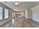 Bright living room with an open-concept kitchen featuring modern lighting fixtures at 58 Longhorn Way, Auburn, GA 30011