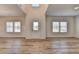 Spacious living room with a light wood floor, neutral walls and white trim at 58 Longhorn Way, Auburn, GA 30011