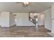 Bright living room with an open-concept floorplan, staircase, and contemporary flooring at 58 Longhorn Way, Auburn, GA 30011