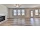 Inviting living room featuring a cozy fireplace and ample natural light from large windows at 58 Longhorn Way, Auburn, GA 30011