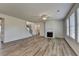 Bright living room with hardwood floors, fireplace, and plenty of natural light from large windows at 58 Longhorn Way, Auburn, GA 30011