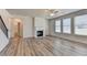 Open living room with a fireplace, staircase, and lots of natural light at 58 Longhorn Way, Auburn, GA 30011
