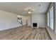 Bright living room with a fireplace, staircase, and ample natural light from the windows at 58 Longhorn Way, Auburn, GA 30011