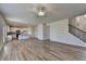 Bright living room with an open floorplan showing the staircase and kitchen at 58 Longhorn Way, Auburn, GA 30011