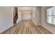 Open-concept living area features wood-look floors, stairs, and plenty of natural light at 58 Longhorn Way, Auburn, GA 30011