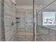 Updated tile shower featuring a built-in bench and decorative, neutral colored tile at 58 Longhorn Way, Auburn, GA 30011