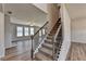 Staircase with carpeted steps and dark railing connects multiple levels within home at 58 Longhorn Way, Auburn, GA 30011