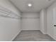 Spacious walk-in closet with wire shelving and neutral colored carpet flooring at 58 Longhorn Way, Auburn, GA 30011