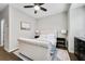 Bedroom with a large window, modern ceiling fan, tufted headboard and neutral decor at 635 Broadview Ne Pl, Atlanta, GA 30324