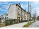 Brick townhome exterior featuring neutral trim, fenced yard, and sidewalk access at 635 Broadview Ne Pl, Atlanta, GA 30324