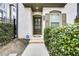 Inviting townhome entrance with brick facade, arched entryway, and verdant landscaping at 635 Broadview Ne Pl, Atlanta, GA 30324