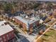 Aerial view of a red brick multi-unit building with mature trees, surrounding neighborhoods and fall foliage at 4143 N Swann St, Covington, GA 30014