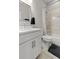 Bathroom featuring white cabinets, a framed mirror, and a shower-tub combo at 4143 N Swann St, Covington, GA 30014