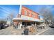 Exterior view of 'Bread and Butter' cafe, showing street-side seating and its prominent corner location at 4143 N Swann St, Covington, GA 30014