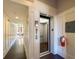 Hallway featuring an elevator for easy access, wainscoting, and hardwood flooring in a well-lit space at 4143 N Swann St, Covington, GA 30014