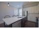 Bright kitchen featuring stainless steel appliances, white cabinets, island, and dark wood floors at 4143 N Swann St, Covington, GA 30014