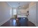 Bright kitchen featuring stainless steel appliances, white cabinets, island, and dark wood floors at 4143 N Swann St, Covington, GA 30014