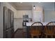 Bright kitchen with stainless steel appliances, white cabinets, and dark wood floors at 4143 N Swann St, Covington, GA 30014