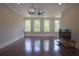 Spacious living room with four large windows with shutters, ceiling fan, and dark hardwood floors at 4143 N Swann St, Covington, GA 30014