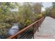 Modern walking bridge over a serene river, framed by lush trees and natural surroundings at 4143 N Swann St, Covington, GA 30014