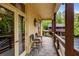 An outdoor balcony with stone floor, wooden railings, and chairs overlooks the surrounding trees at 44 Muscogee Nw Ave, Atlanta, GA 30305