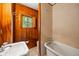 Rustic bathroom featuring wood paneling, white fixtures, and charming hexagonal tile at 44 Muscogee Nw Ave, Atlanta, GA 30305