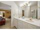 Bright bathroom featuring a double vanity, white cabinets, and ample counter space at 44 Muscogee Nw Ave, Atlanta, GA 30305