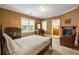 Inviting bedroom with a fireplace, large windows, and classic furnishings at 44 Muscogee Nw Ave, Atlanta, GA 30305