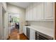 Butler's pantry boasts modern cabinets, a sink, and stylish appliances next to the dining room at 44 Muscogee Nw Ave, Atlanta, GA 30305