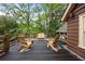 Outdoor deck featuring three wooden chairs; perfect for relaxing and enjoying the surrounding nature at 44 Muscogee Nw Ave, Atlanta, GA 30305